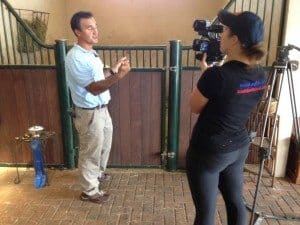 Maat holding the camera for WPTV reporter during an interview