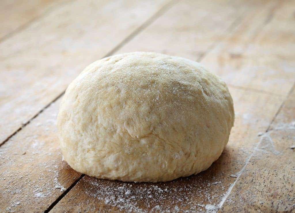 Ultimate no-fail pizza dough recipe. Start Sunday night, and have enough dough for 2-3 meals! Easy step-by-step directions. Make it today! From FrugalChicken