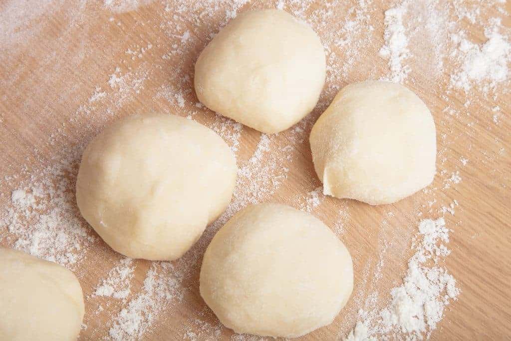 Ultimate no-fail pizza dough recipe. Start Sunday night, and have enough dough for 2-3 meals! Easy step-by-step directions. Make it today! From FrugalChicken