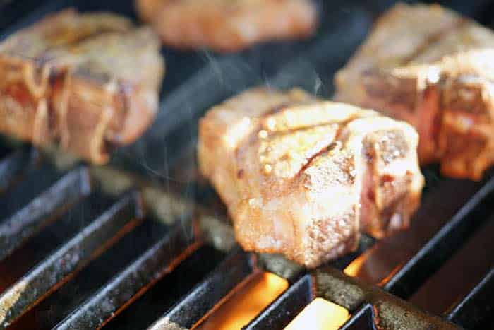 How to grill lamb chops, starts by getting your grill screaming hot so the meat will sear quickly.