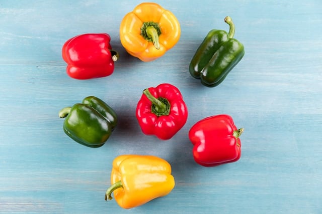 Variety of pepper on top of a blue table