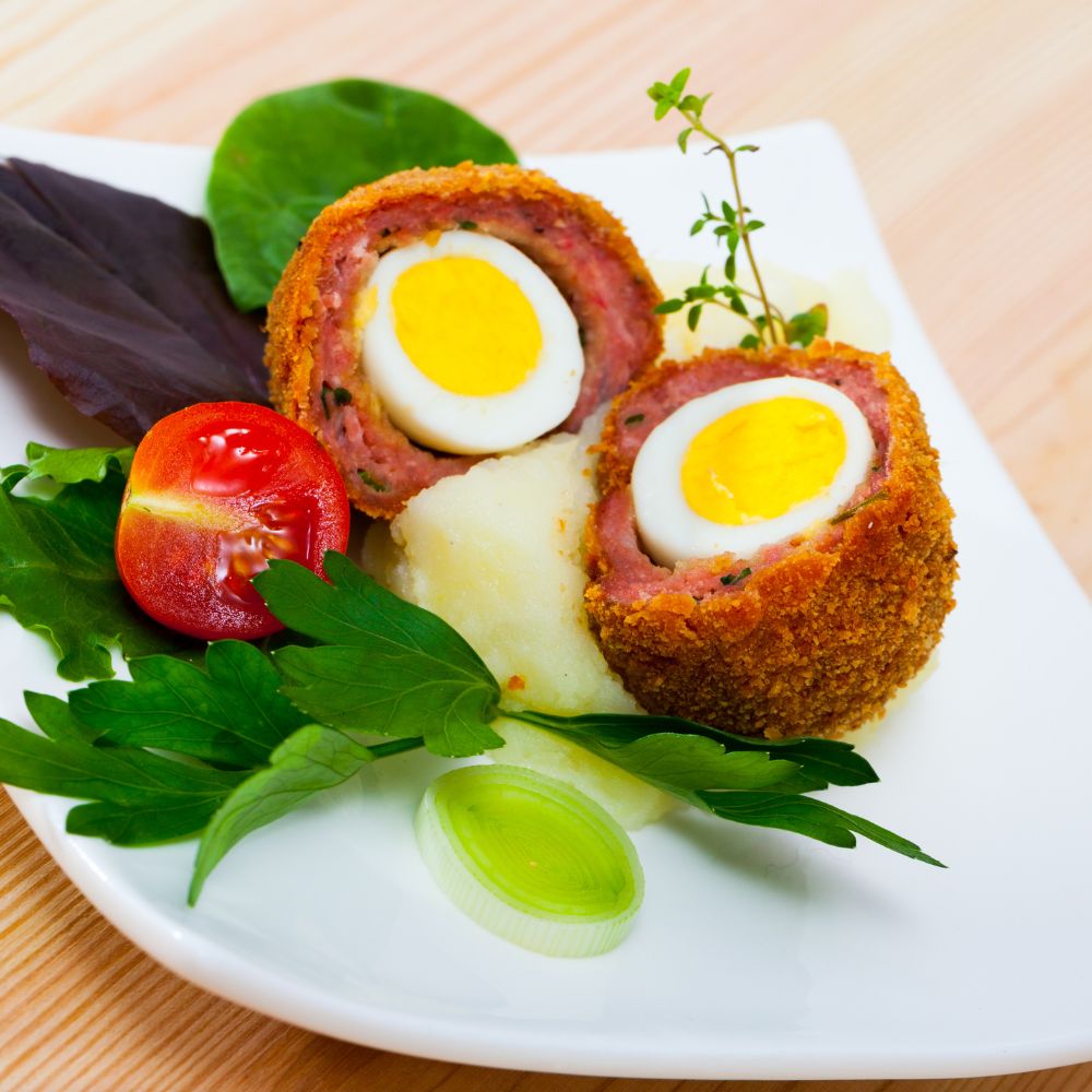 Scotch Quail Egg on plate with garnishes