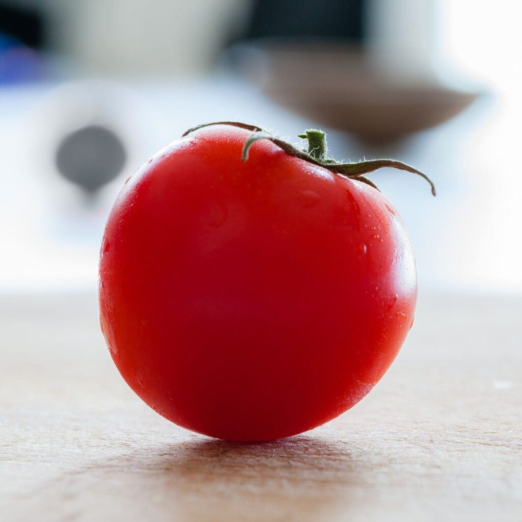Beautiful tomato sitting on a counter with blurred background
